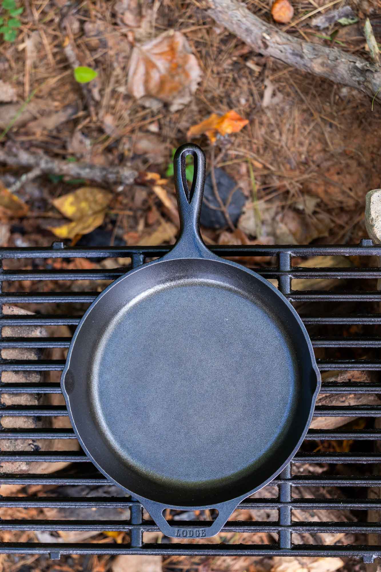 Lodge cast iron skillet on a camp grill grate