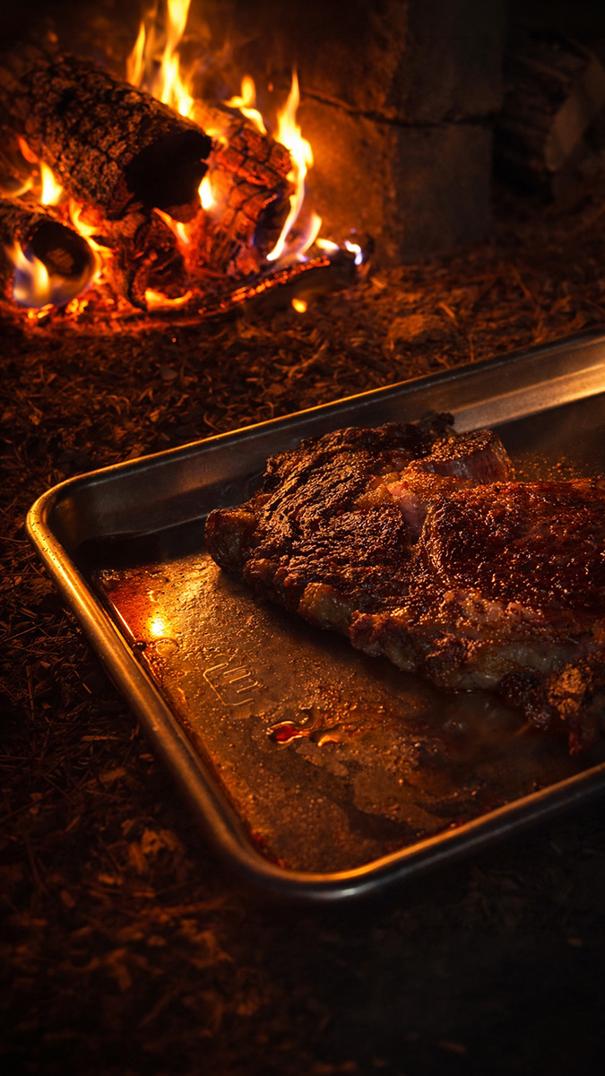 Made In quarter sheet pan with steak by campfire